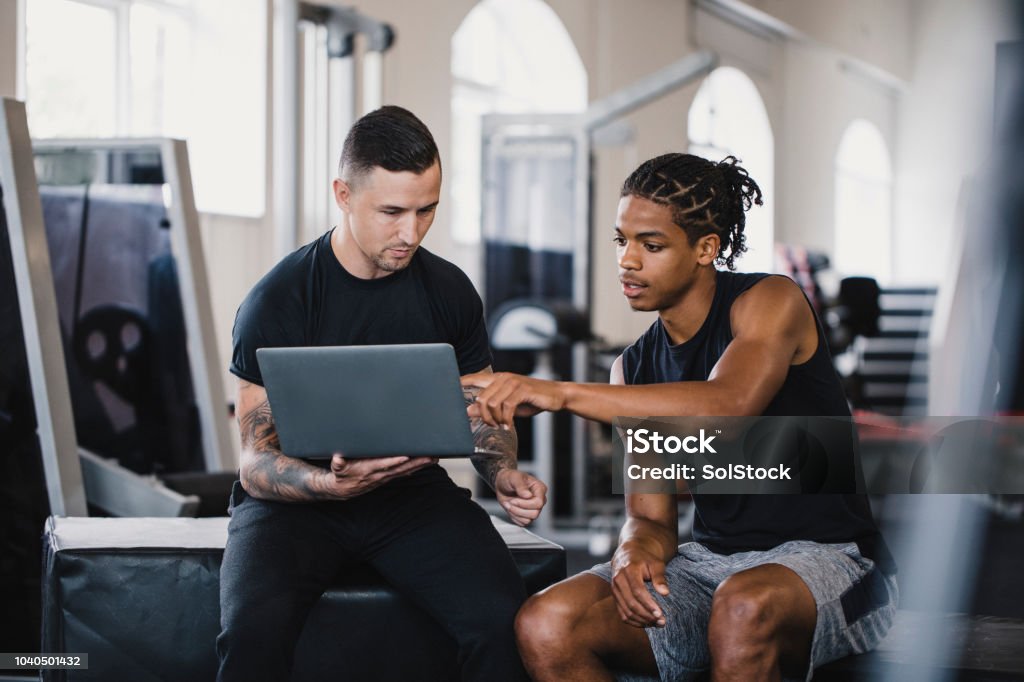 Trainer And Client Personal Trainer Consulting With A Client Stock Photo - Download Image ...