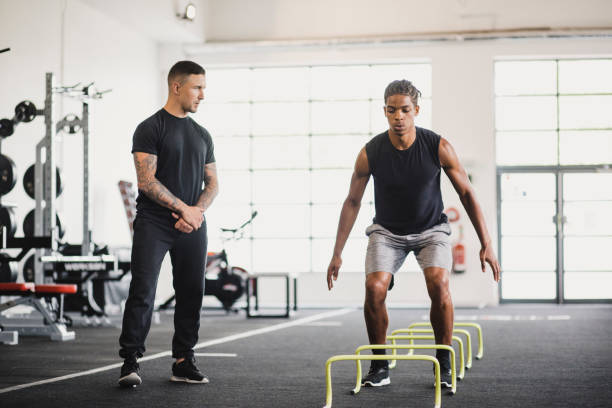 istock Stretching in the Gym with a Personal Trainer 1040504298