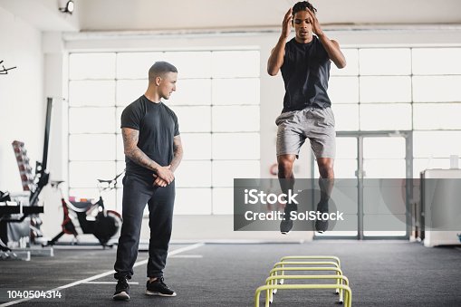 istock Stretching in the Gym with a Personal Trainer 1040504314