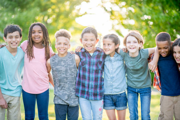 istock Diverse group of kids having fun in the park 1040505358