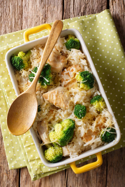 istock Dietary foods: rice baked with broccoli, chicken and cheese close-up. Vertical top view 1040505954