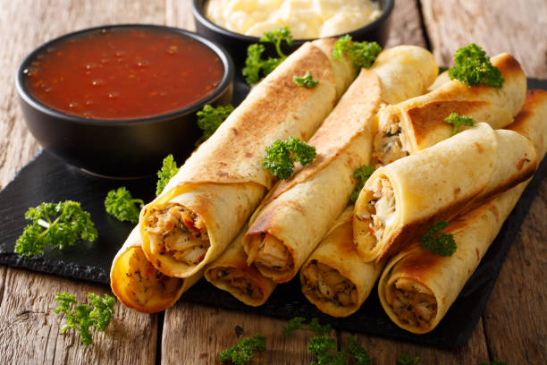 istock Tasty taquitos with chicken and two sauces close-up. horizontal 1040506210