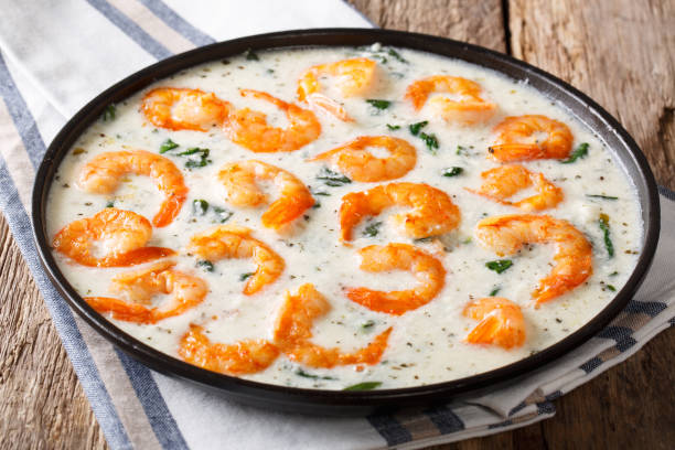 istock Shrimp with spinach and spices in creamy cheese sauce close-up. horizontal 1040510942