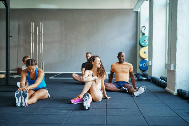 istock People laughing together on a gym floor after working out 1040511058