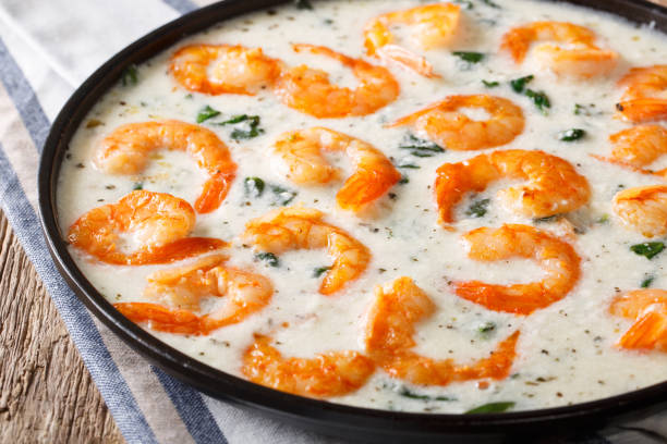 istock Delicious shrimps with spinach in creamy cheese sauce close-up on a table. Horizontal 1040514062