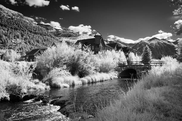 Black and White Landscape with Mountains and a Town by the River stock photo