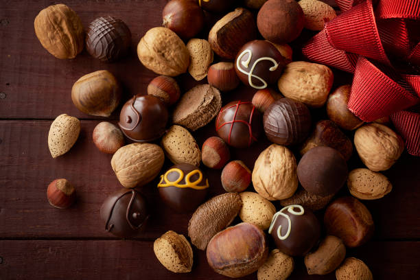 Assortment of Nuts and Round Chocolates with a Red Bow stock photo