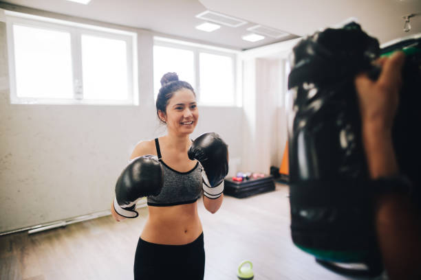 istock Young woman boxing 1040527956