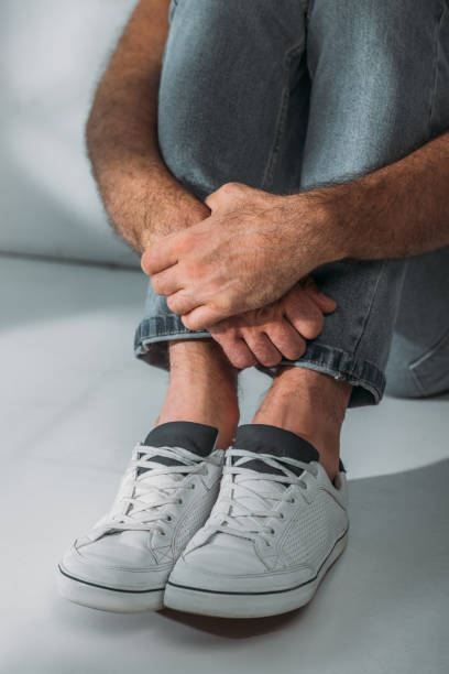 istock cropped shot of scared stressed man sitting in floor 1040528990