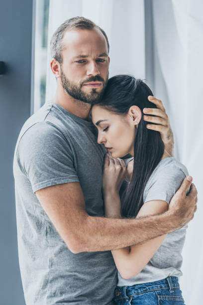 istock upset bearded man hugging and supporting depressed young woman 1040530734