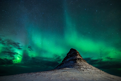 Famous kirkjufell mountain in iceland with aurora borealis in winter.