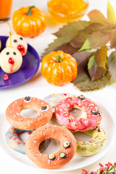 istock Halloween donuts with pumpkin juice and autumn leaves. 1040540072