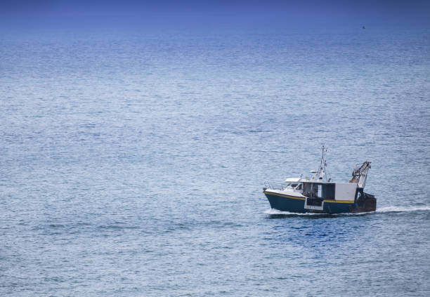 istock Homecoming: Tired fishermans ship approaching after a hard day 1040544876