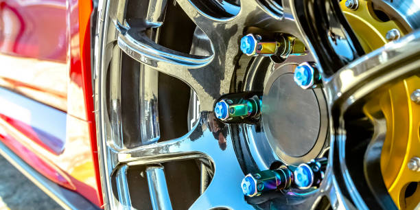 Rim of a red car with blue bolt caps
