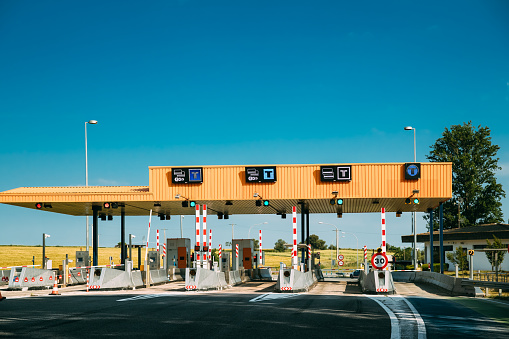 Cars Passing Through The Automatic Point Of Payment On A Toll Road. Point Of Toll Highway, Toll Station. Highway Toll Plaza Or Turnpike Or Charging Point, Entrance On Motorway.