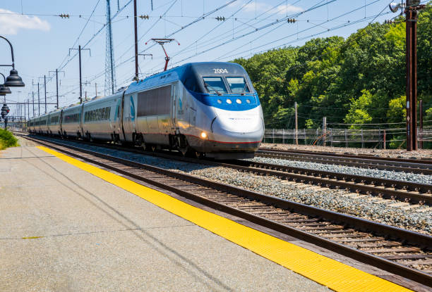 A High Speed Acela Passenger Train Moving Very Fast Past The Station In Perryville Maryland A high speed Acela train moving very fast. harpers ferry photos stock pictures, royalty-free photos & images