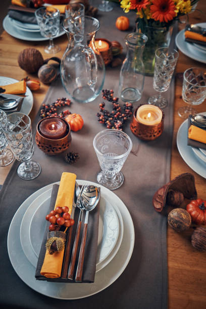istock Decorated Table for Thanksgiving Dinner with Candles, Pumpkins, Leafs and Nuts 1040586110