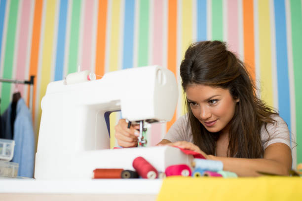 istock Fashion designer sewing with sewing machine 1040591800