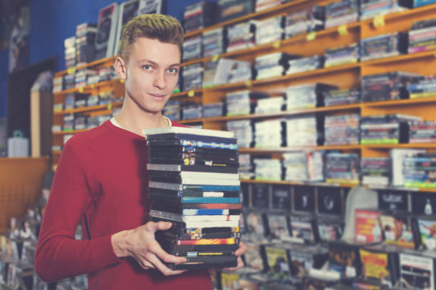 istock guy holding pile of boxes with DVDs 1040603930