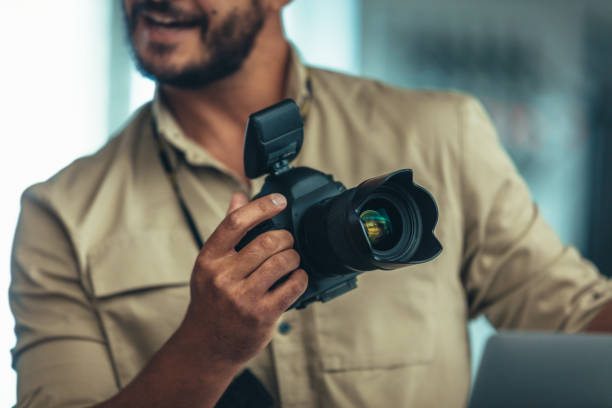 istock Close up of man holding a digital camera 1040608774