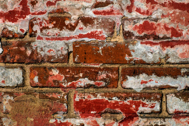 istock Surface of old red bricks with shabby paint 1040609180