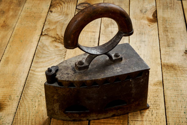istock vintage old rusty iron on a bright wooden table 1040613600