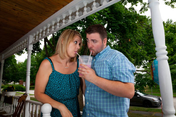istock Young Caucasian couple flirt with one another and drink 1040614356