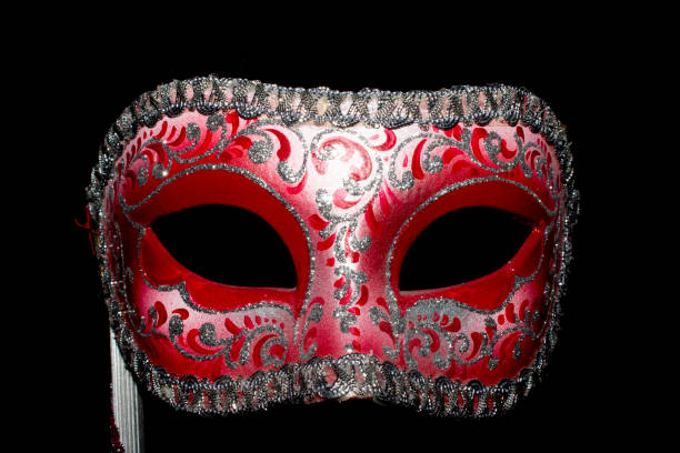 istock Venetian Masquerade Red and Silver Ball Mask on Black Background 1040616894