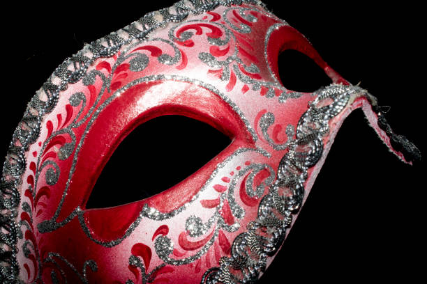 istock Venetian Masquerade Red and Silver Ball Mask on Black Background 1040619044