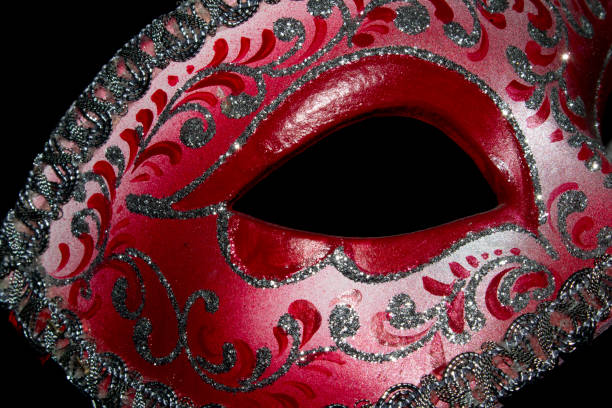 istock Venetian Masquerade Red and Silver Ball Mask on Black Background 1040620172