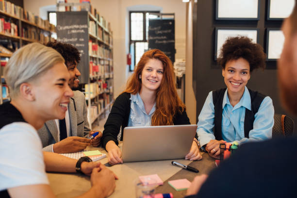 istock Friends with laptop in the library 1040620274