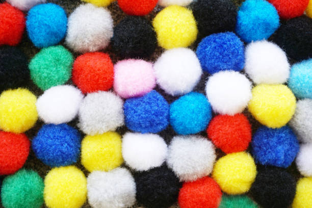 istock Bacground with many colorful fluffy wool pom pom balls background 1040628988
