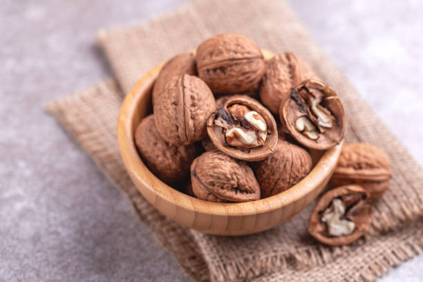 istock Whole walnuts in wooden bowl. Harvest concept. 1040632606