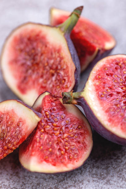 istock Sliced figs on grey slate background.  Close up 1040634802