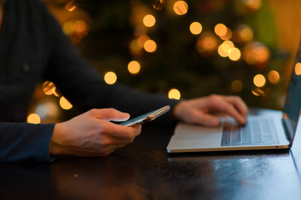 istock Midsection Of Man Using Smart Phone Against Illuminated Christmas Tree 1040638686