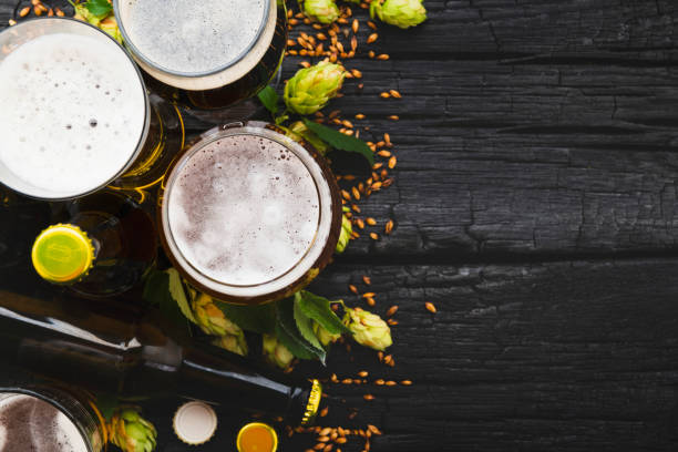 istock Beer in a glass with green hops and space for text. Top View 1040643486