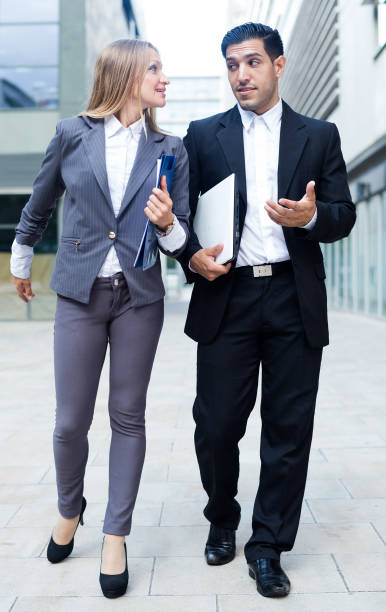 empresario y su colega mujer traje va con carpeta - success signing businesswoman serious fotografías e imágenes de stock