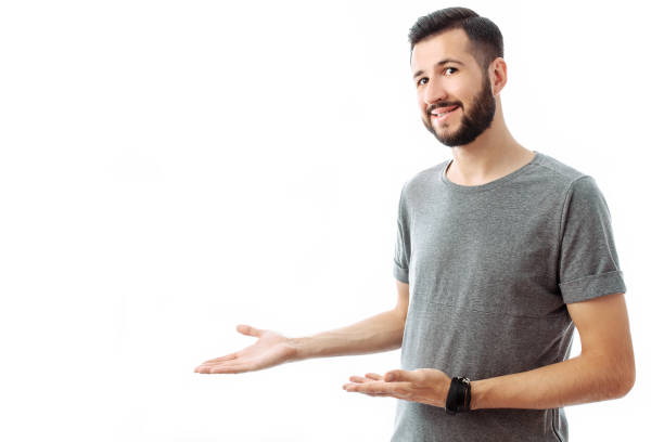 istock Young cheerful bearded man pointing finger at empty space on background isolated on white background 1040670588