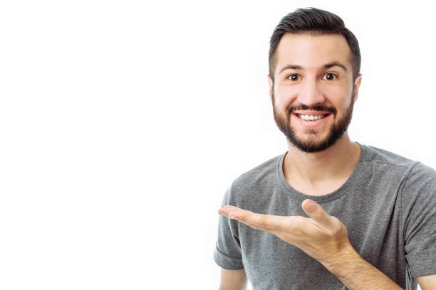 istock Young cheerful bearded man pointing finger at empty space on background isolated on white background 1040670644