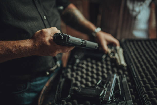 Buying a gun on black market Two men, criminal selling guns on black market in abandoned house, part of. gun revolver stock pictures, royalty-free photos & images