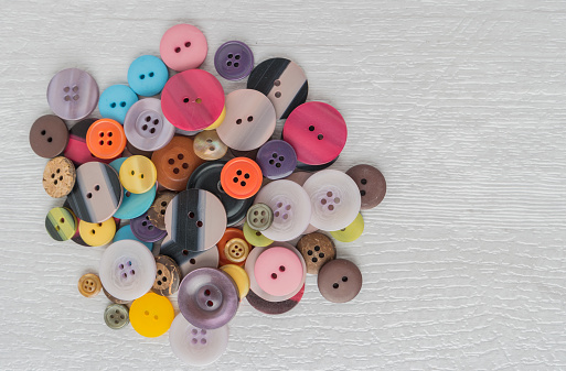 Set of different colored buttons on white background. Top of view