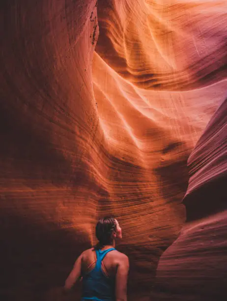 A young woman in awe as she explores Antelope Canyon in Arizona USA.