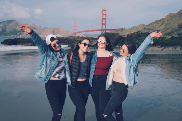 Young Female Friends In San Francisco Five, young, female friends gathering in front of the Golden Gate Bridge for a picture. sorority photos stock pictures, royalty-free photos & images