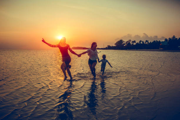 istock family is running on the beach 1040704782