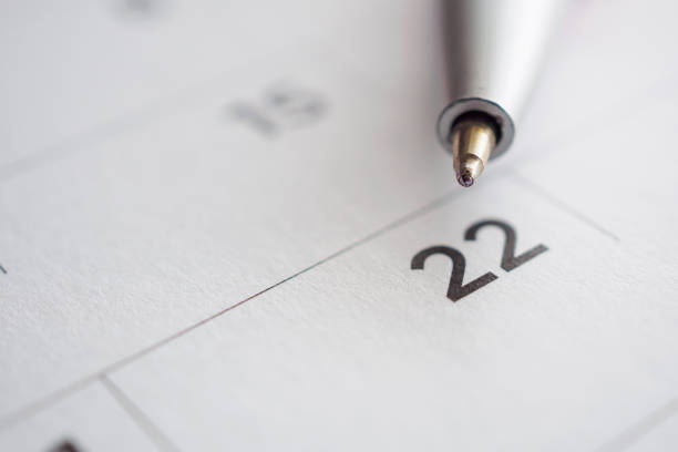 istock Calendar page with pen point at 22nd date 1040705000