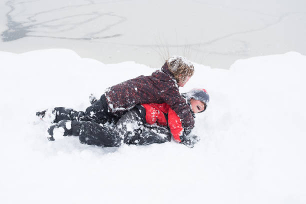 istock Children happy and playful while joyfully sledding during a big snow storm 1040706230