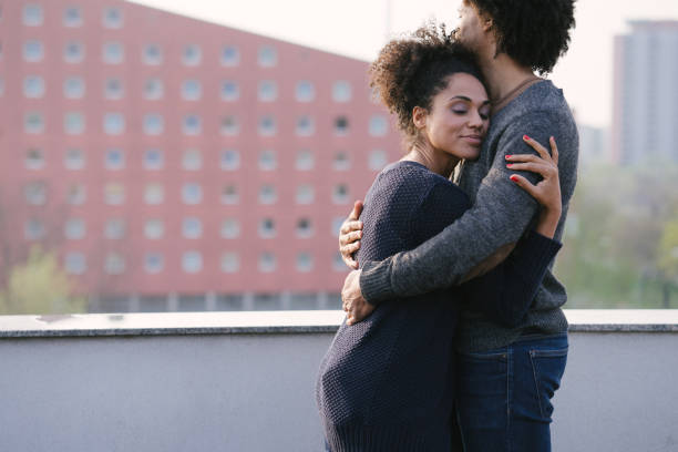 istock Young couple on a rooftop terrace at sunset 1040706548