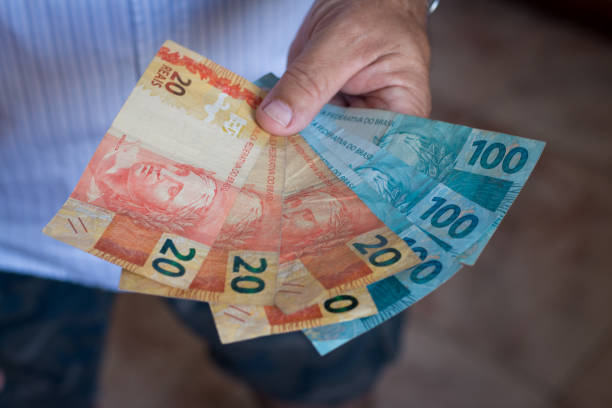 istock Hand holding brazilian money 1040717968