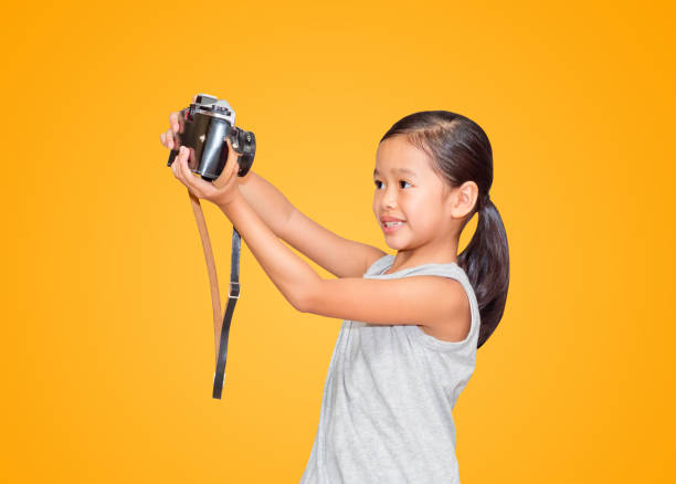 istock Beautiful smiling girl holding a camera. 1040731612