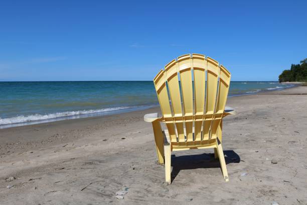 istock Yellow plastic lawn chair on a quiet beach 1040743272